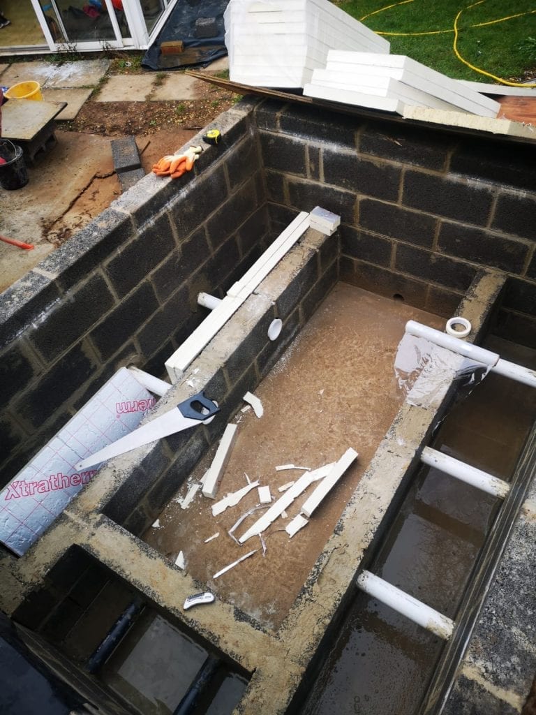 Block-built hot tub seats with jet pipework running through the blockwork