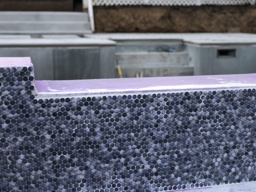 Circular mosaic tiles on the inside of Danny's hot tub
