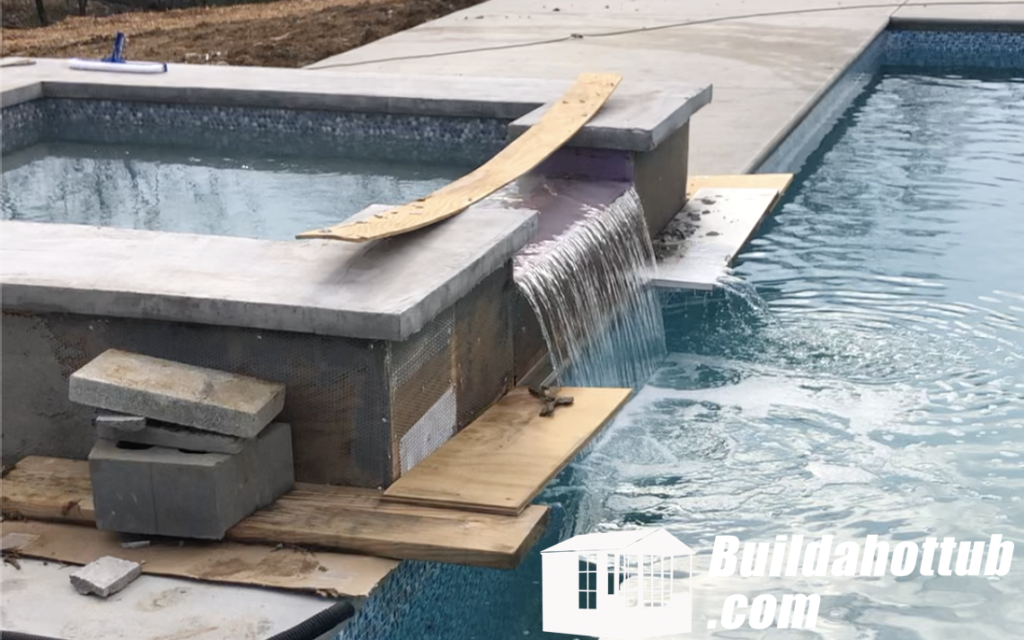 Water spilling over from Danny's hot tub into the pool during testing