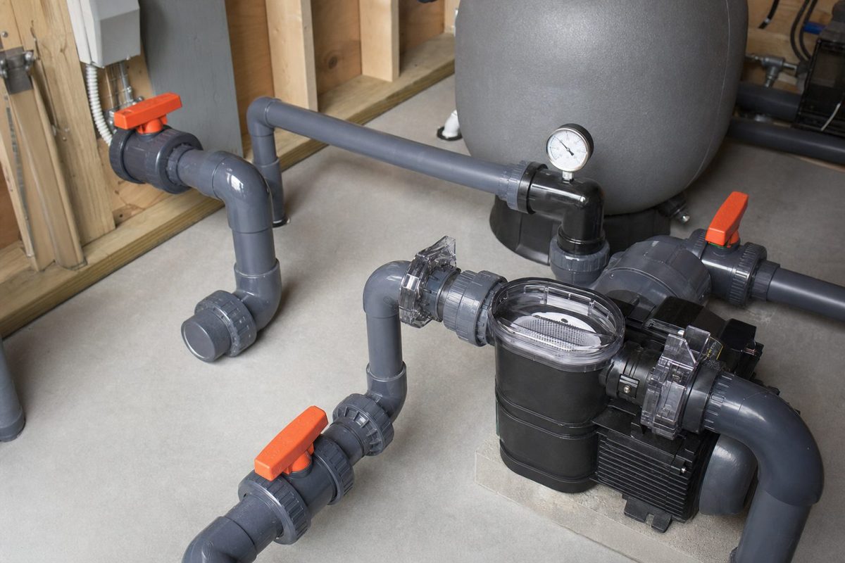 Large hot tub jet pump with 2.5 inch pipework and gate valves in a DIY equipment room