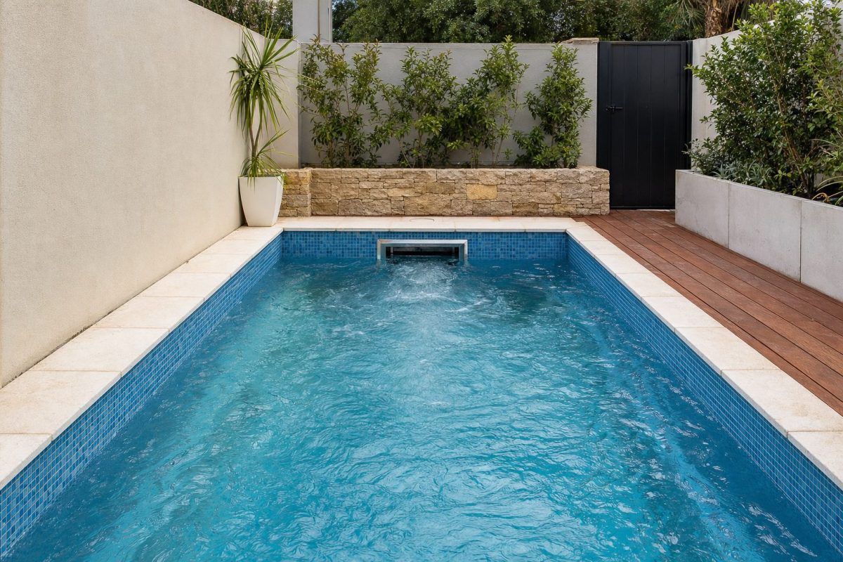 DIY swim spa with a built-in swim jet creating a current across a small tiled pool