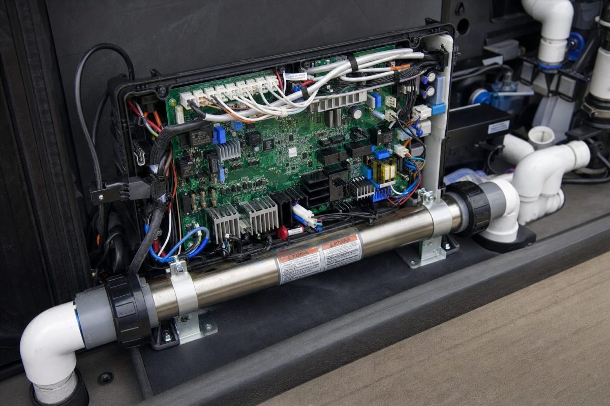 Open Balboa hot tub spa pack showing the circuit board, connectors, fuses and heater