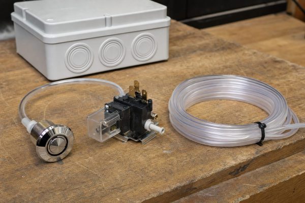 Hot tub air button and pneumatic latching relay with air tubing in a control box