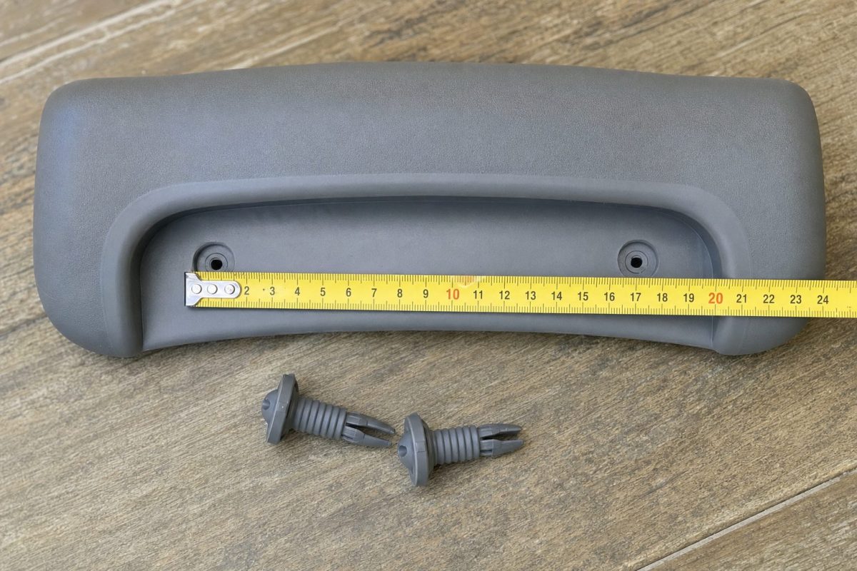 Hot tub headrest pillow being measured with a tape measure across the back attachment holes