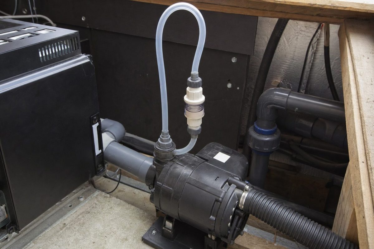 Hot tub air blower with a check valve and an air line looped above the water line