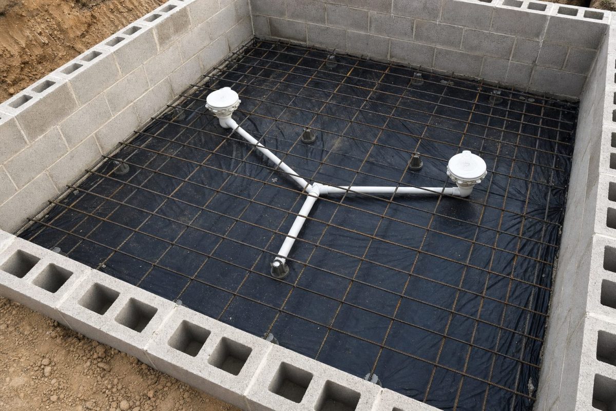 Two main drains wired to the rebar and teed together in the base of an in-ground hot tub before the concrete pour